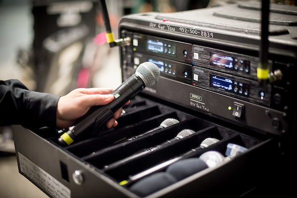 Complete microphone set with stands, wireless handheld mics, and headworn mics arranged neatly